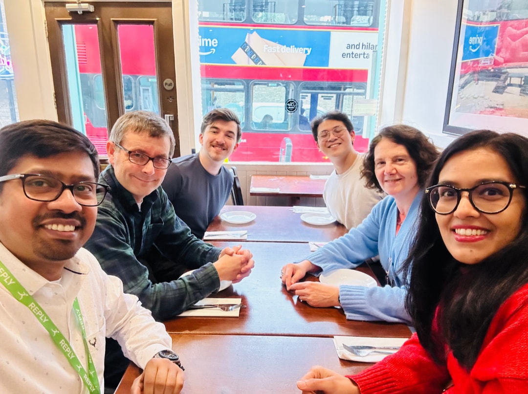 Photo of Valorem and Solidsoft Reply colleagues. Seated at the table (clockwise from front left) : Abhishek Verma, Phil Cullum, Beckham Tuplin, Gabriel Yang from Valorem Reply with Nanditha Kartik and Federica Massagrande, from Solidsoft Reply.